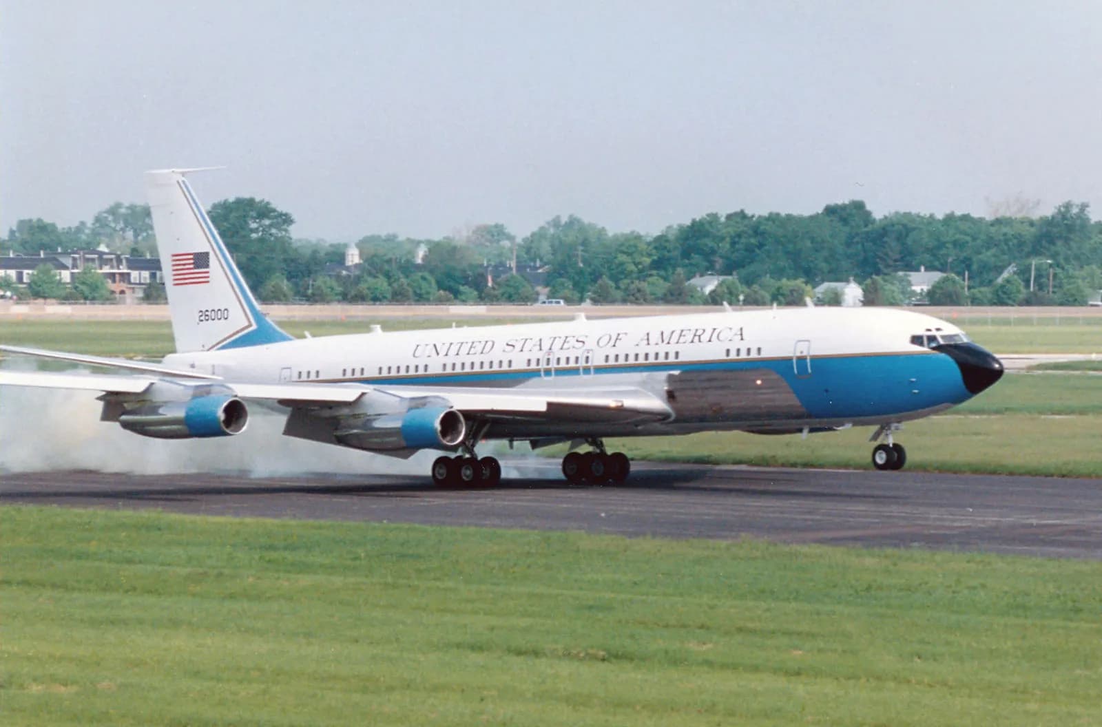 Boeing 707 during landing approach with landing gear deployed.